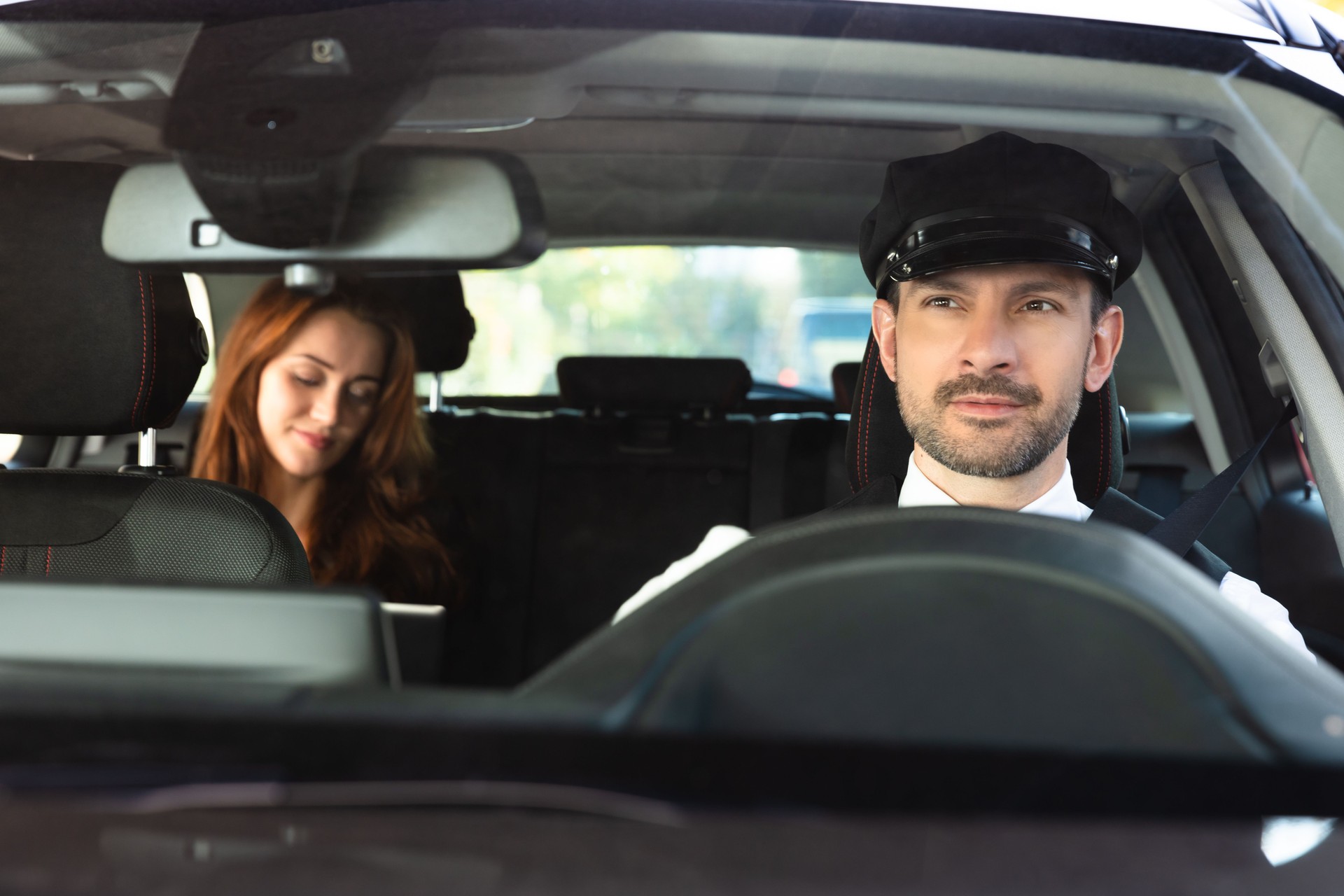 Portrait Of A Smiling Male Chauffeur Driving Car